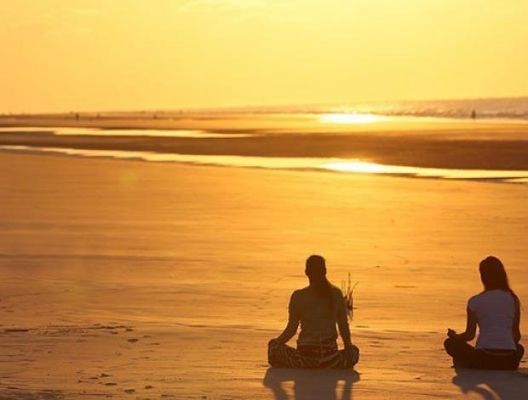 Engage in a calming yoga session on the beach